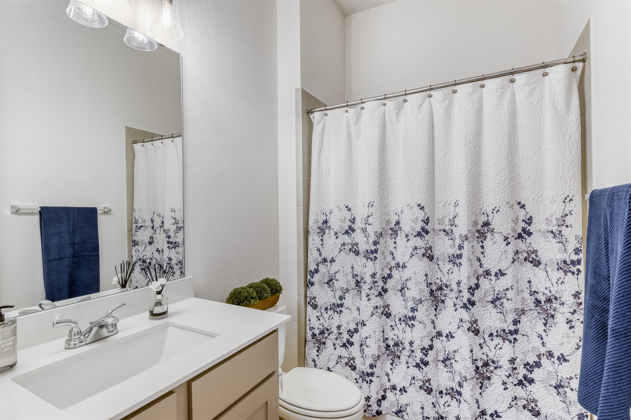 345 Prickly Poppy Loop Kyle, TX 78640 - Photo 24 of 28 Bathroom featuring a shower with curtain and vanity