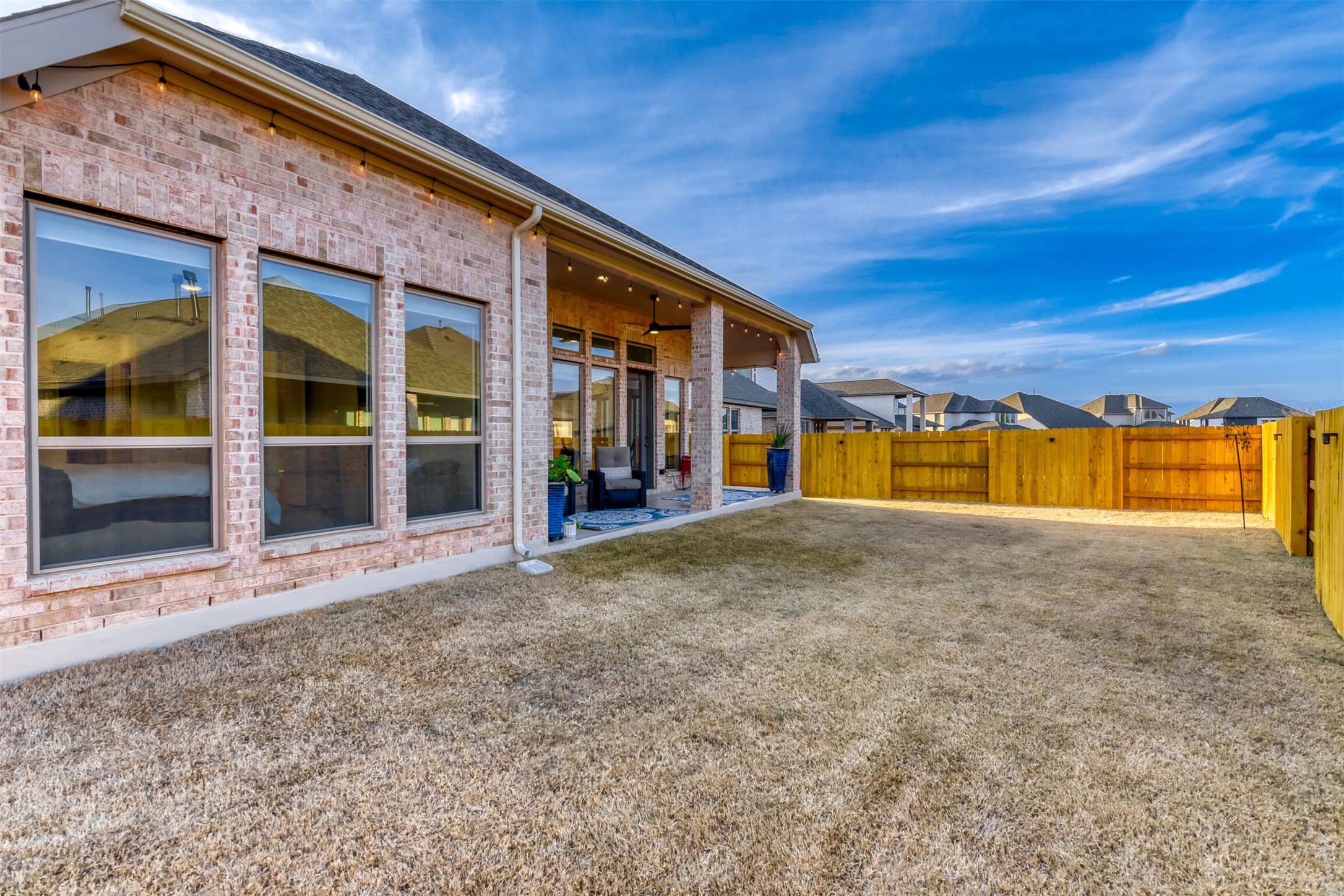 345 Prickly Poppy Loop Kyle, TX 78640 - Photo 27 of 28 Fenced backyard featuring a patio area and a residential view