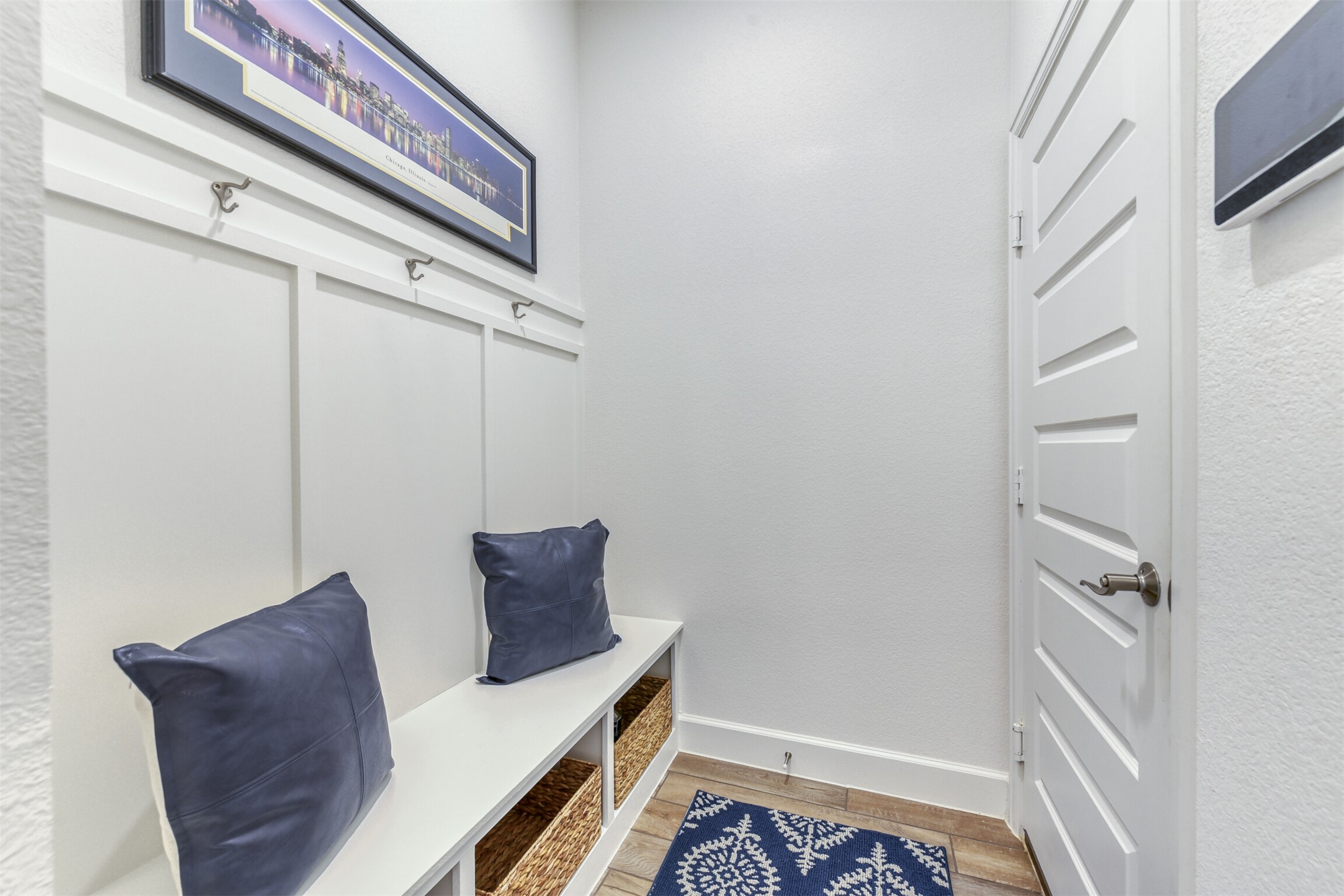 345 Prickly Poppy Loop Kyle, TX 78640 - Photo 5 of 28 Mudroom featuring wood finished floors and a textured wall