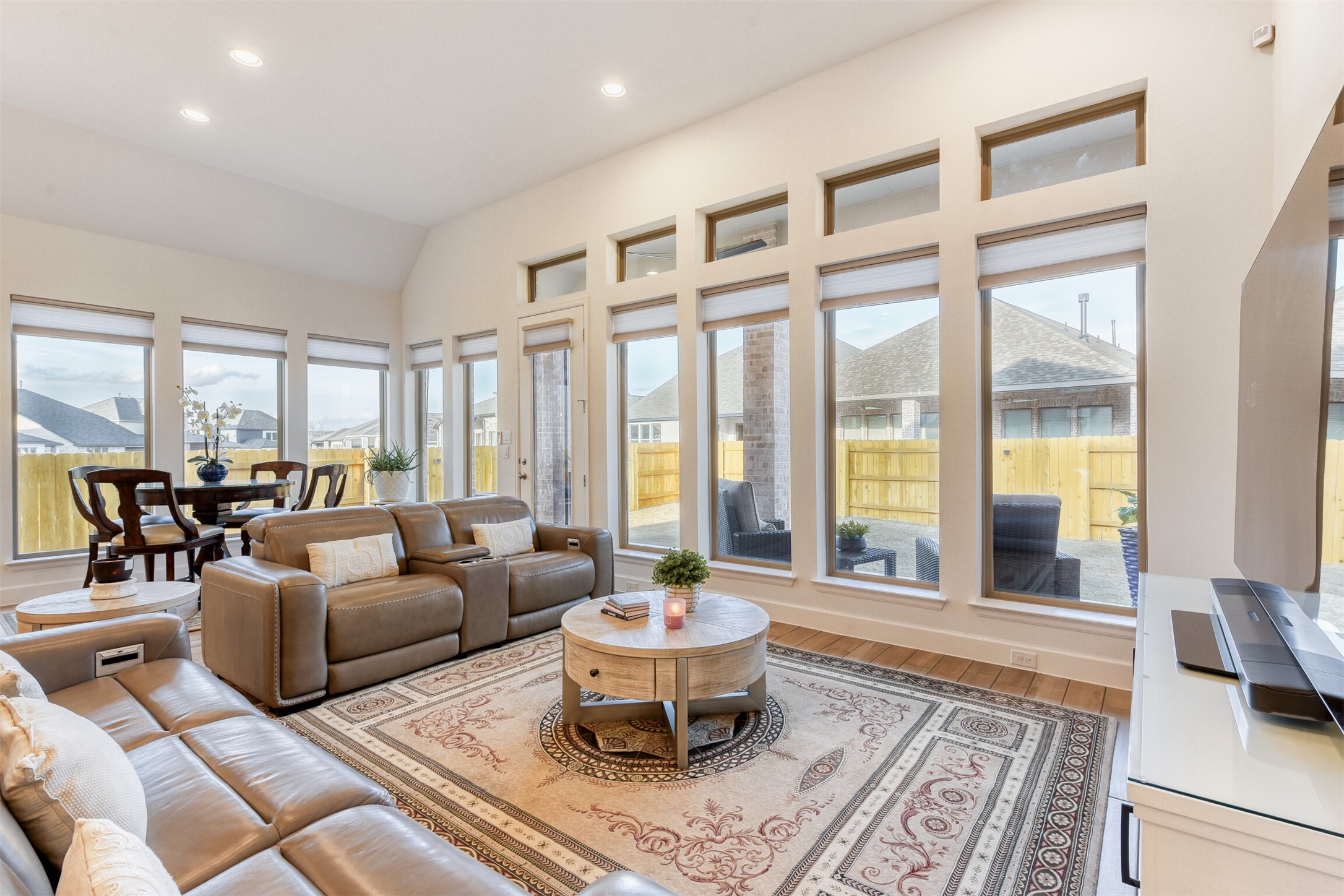 345 Prickly Poppy Loop Kyle, TX 78640 - Photo 8 of 28 Sunroom / solarium featuring wood finished floors, recessed lighting, and vaulted ceiling