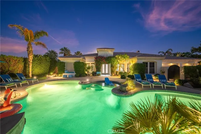a view of a swimming pool with lounge chairs in patio