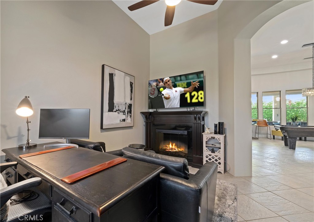 79690 Rancho San Pascual La Quinta, CA 92253 - Photo 17 of 73 a living room with furniture a flat screen tv and a fireplace