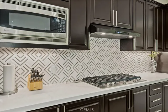 a living room with furniture a large window and a fireplace