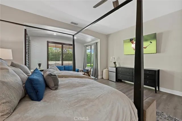 a bed room with a bed and a chair