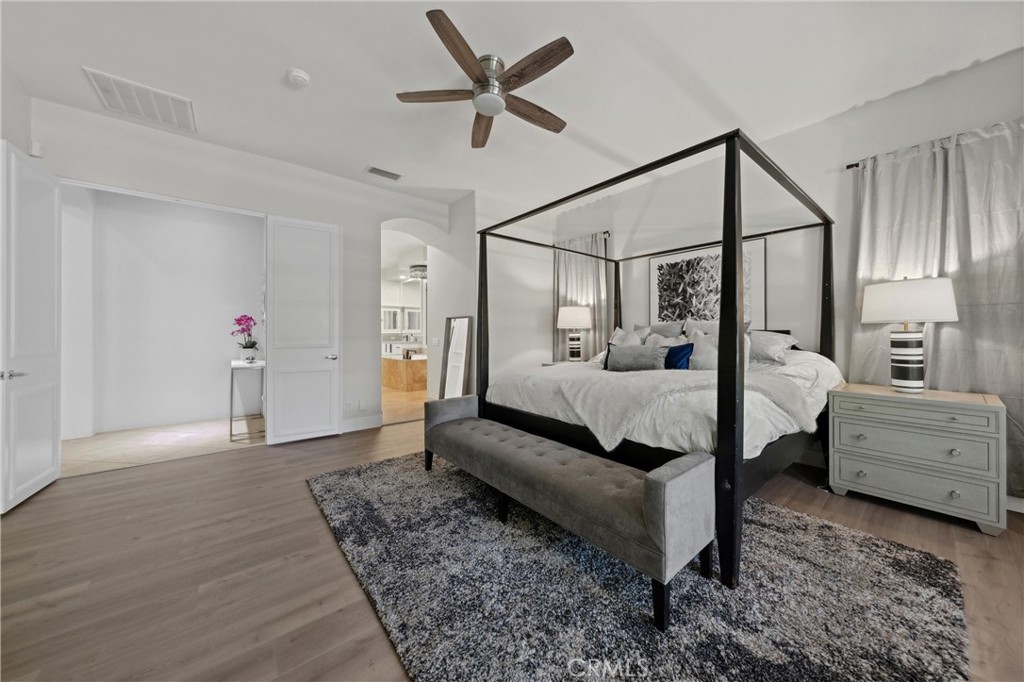 79690 Rancho San Pascual La Quinta, CA 92253 - Photo 30 of 73 a spacious bedroom with a bed and a chandelier