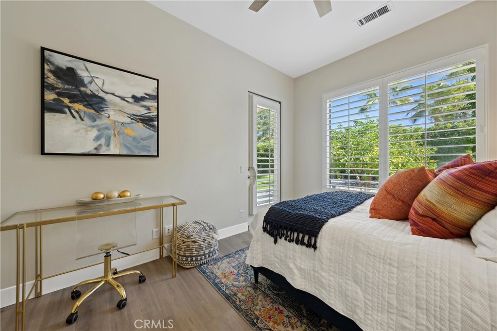 79690 Rancho San Pascual La Quinta, CA 92253 - Photo 41 of 73 a bedroom with a bed and wooden floor