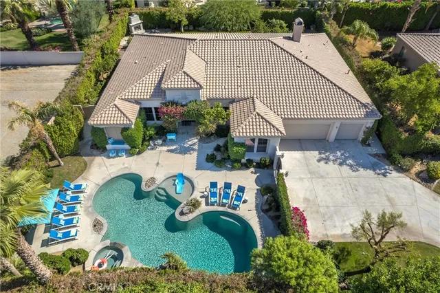 a view of a house with swimming pool and sitting area