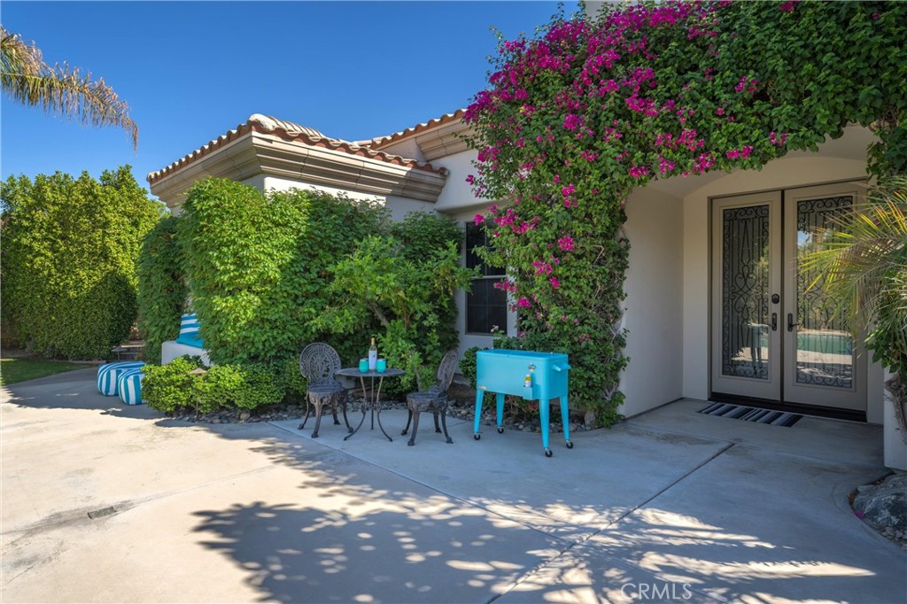 79690 Rancho San Pascual La Quinta, CA 92253 - Photo 50 of 73 a view of a patio with table and chairs and potted plants