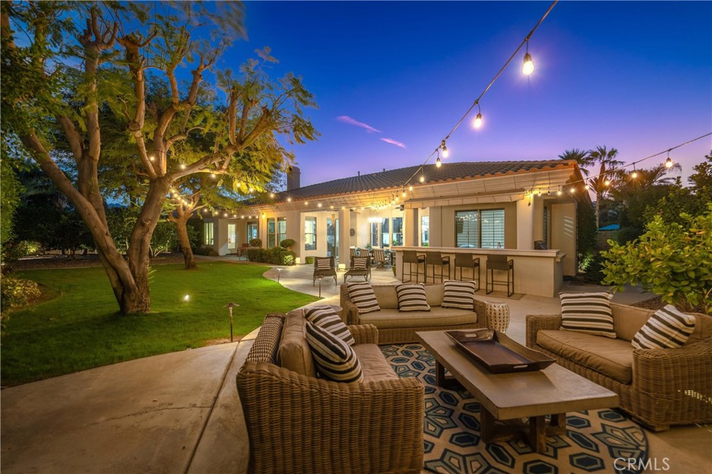 79690 Rancho San Pascual La Quinta, CA 92253 - Photo 59 of 73 a view of a patio with couches and table and chairs with plants and garden