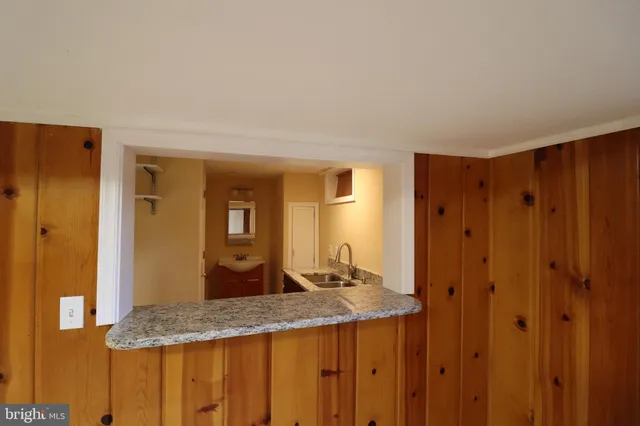 a bedroom with a bed and a refrigerator