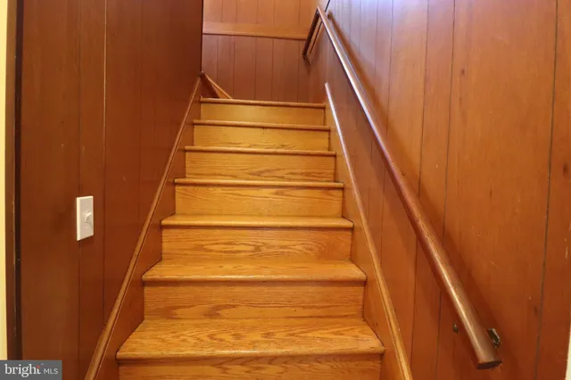 a bathroom with a granite countertop shower and a toilet