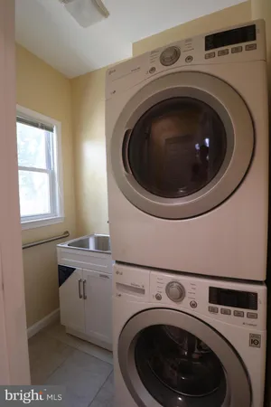 a utility room with sink dryer and washer