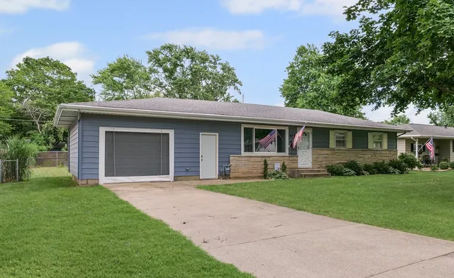 a front view of house with yard and green space