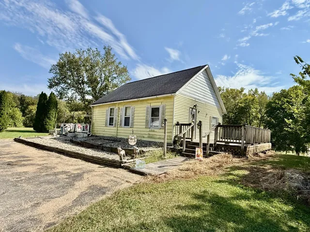 a front view of house with yard outdoor seating and barbeque oven