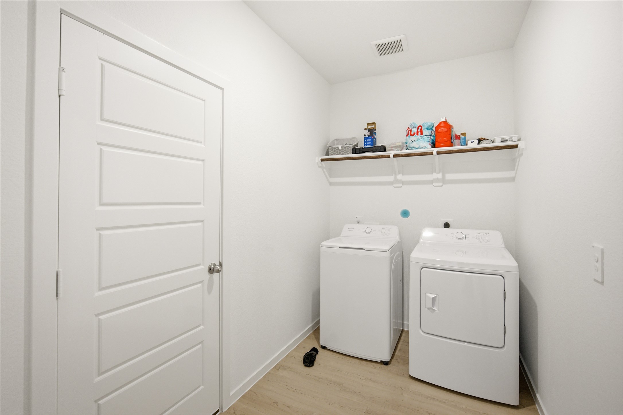 7 Robin Court Angleton, TX 77515 - Photo 23 of 27 Laundry room — Dedicated laundry room with washer, dryer, and overhead storage shelf.
