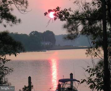 14232 Foxhall Road, Unit 17 Dowell, MD 20629 - Photo 2 of 11 a view of a lake with a mountain in the background
