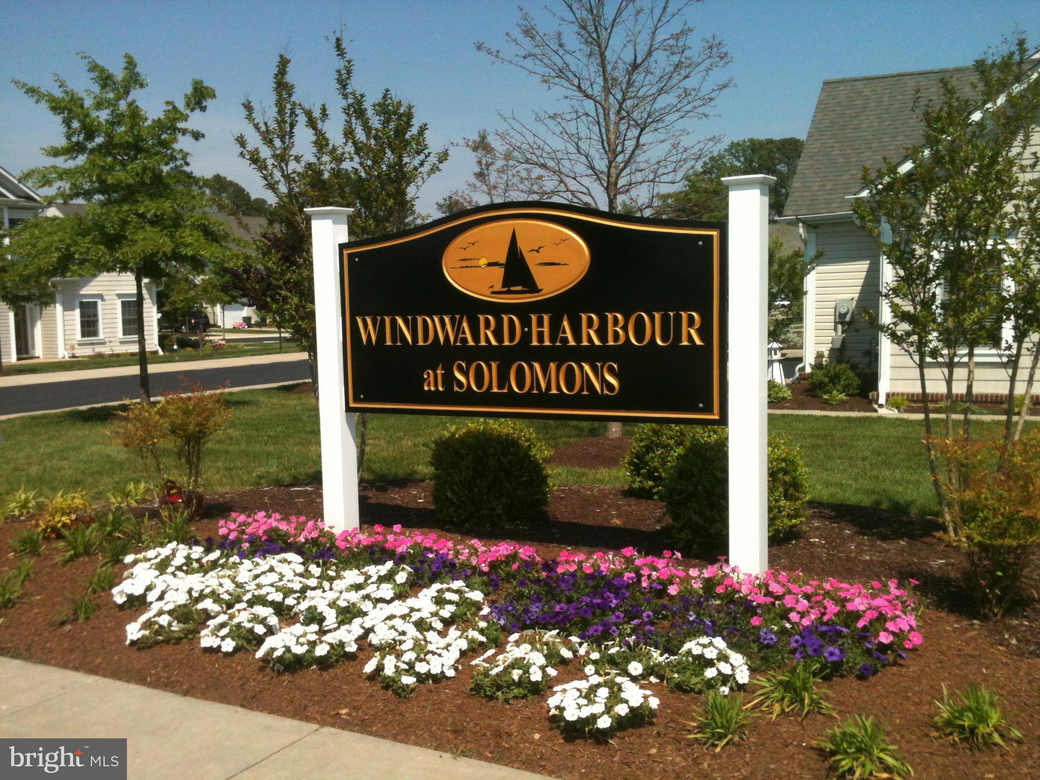 14232 Foxhall Road, Unit 17 Dowell, MD 20629 - Photo 3 of 11 a sign that is sitting in front of flowers