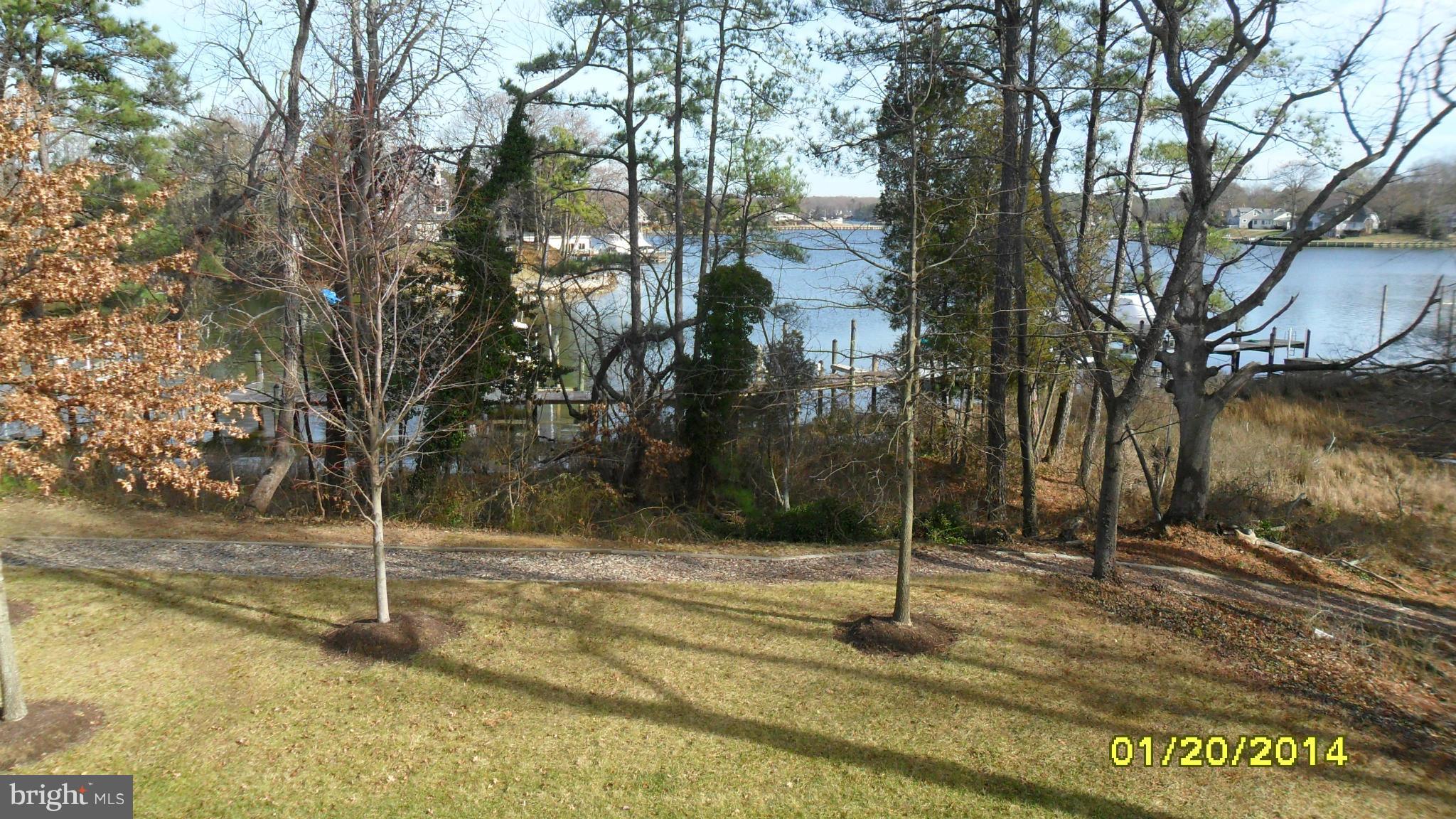 14232 Foxhall Road, Unit 17 Dowell, MD 20629 - Photo 4 of 11 a backyard of a house with lots of trees