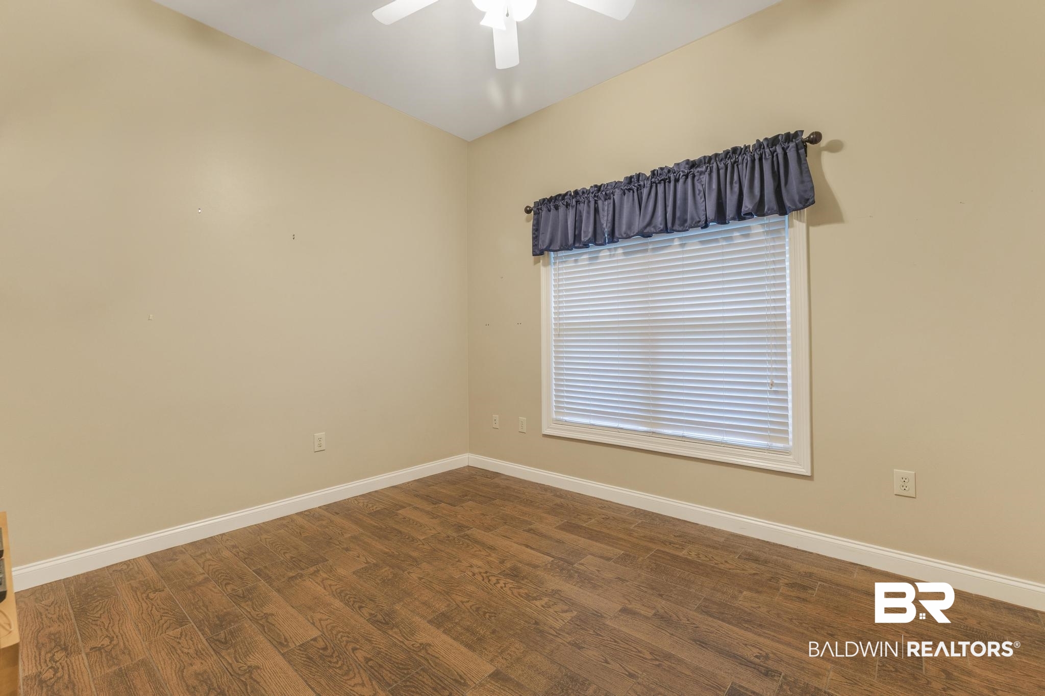13612 Rue Royal Lane Silverhill, AL 36576 - Photo 35 of 65 Empty room featuring dark wood-type flooring and a ceiling fan