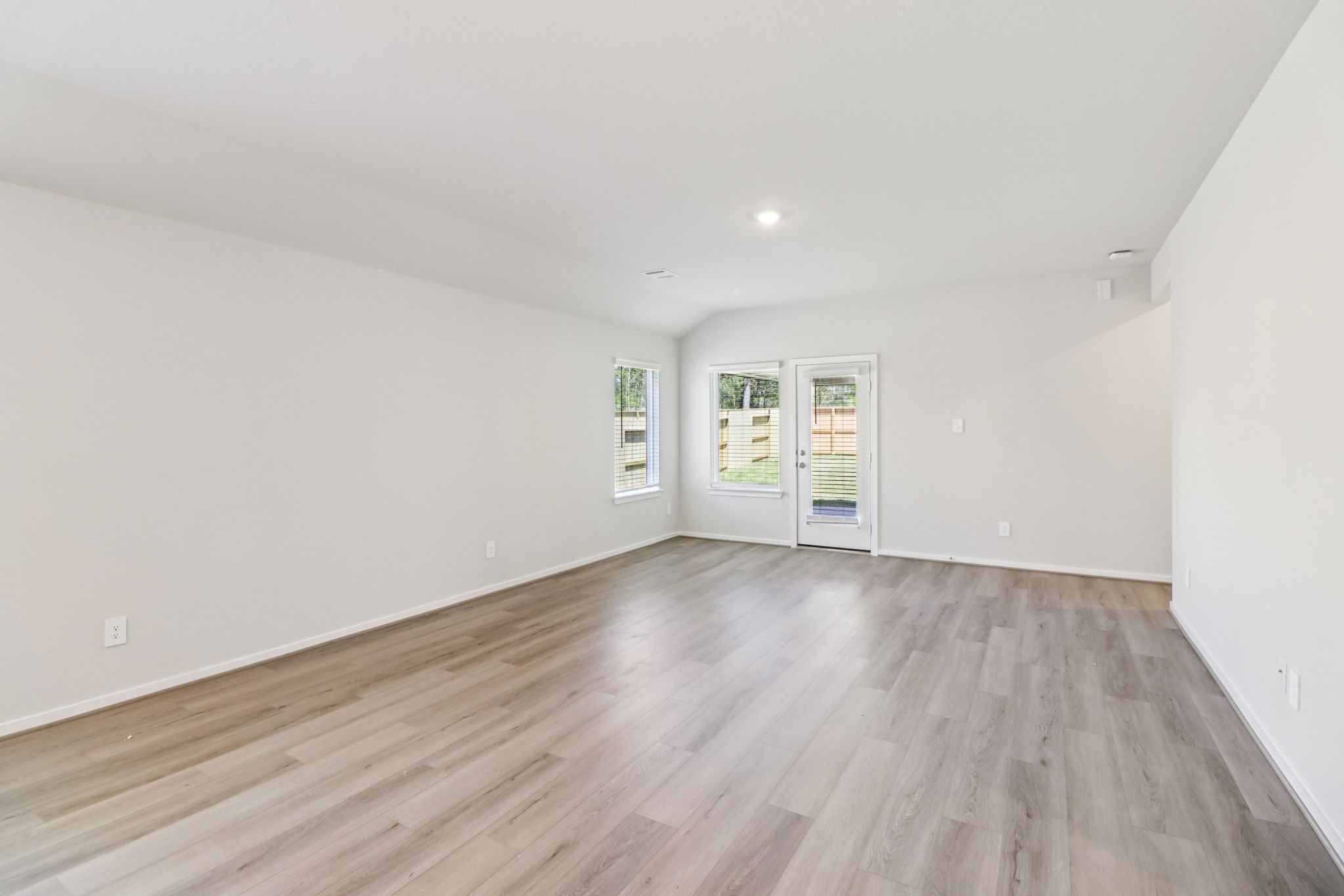16273 Parish Pointe Court Conroe, TX 77302 - Photo 3 of 29 an empty room with wooden floor and windows