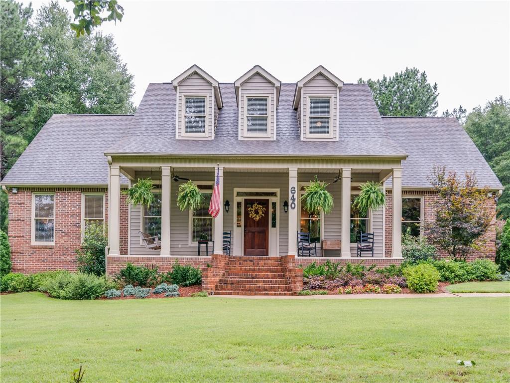 640 Burg Road Locust Grove, GA 30248 - Photo 1 of 1 front view of a brick house with a yard