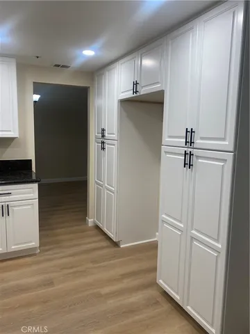 a view of a refrigerator in kitchen and wooden floor