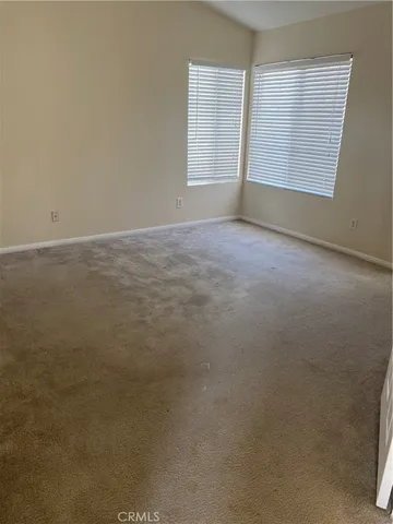 an empty room with a empty space and windows