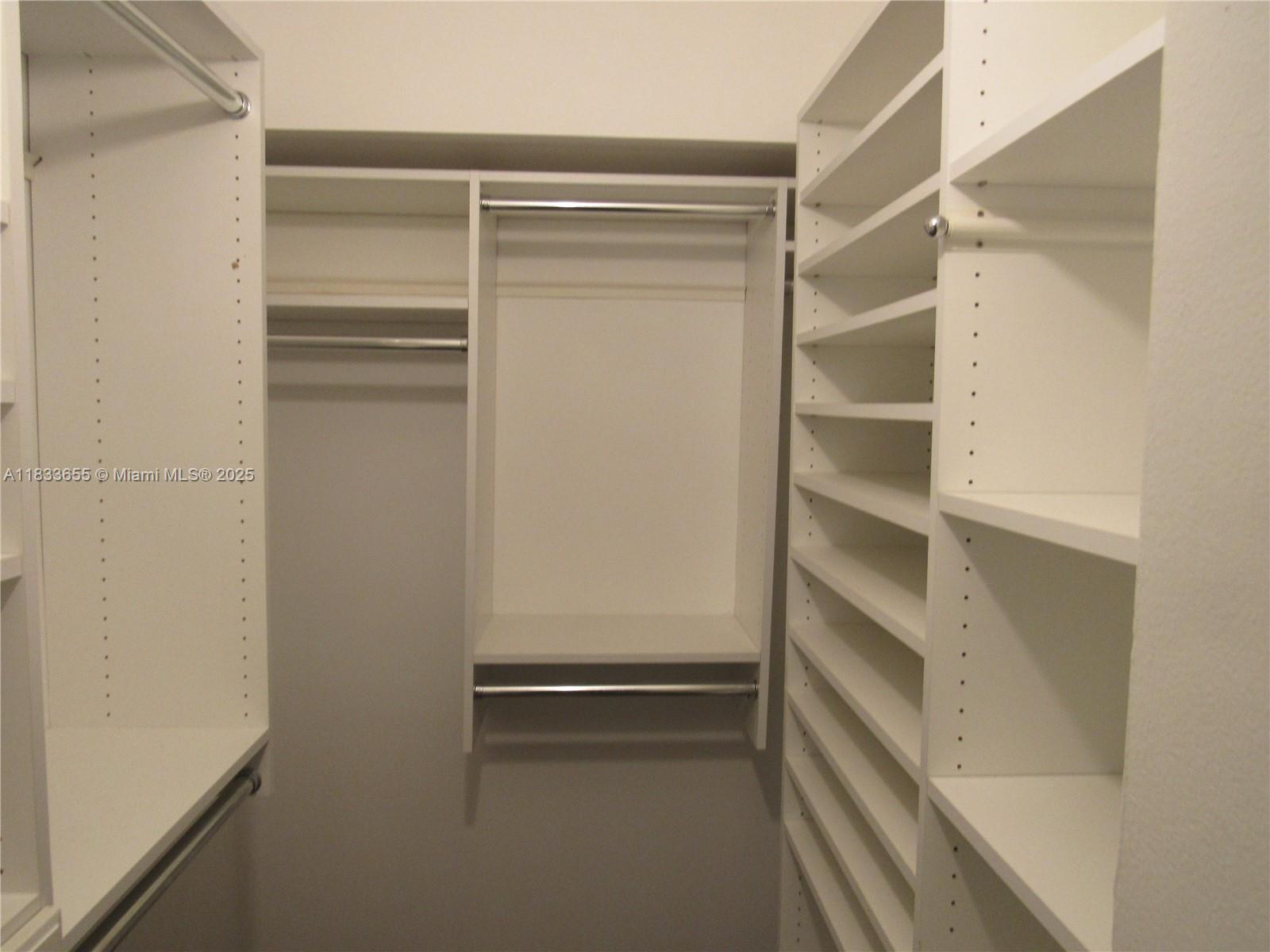 1101 River Reach Drive, Unit 418 Fort Lauderdale, FL 33315 - Photo 11 of 54 a view of walk in closet with empty racks