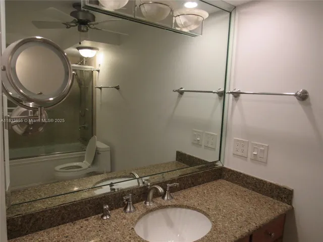 a bathroom with a shower and a sink
