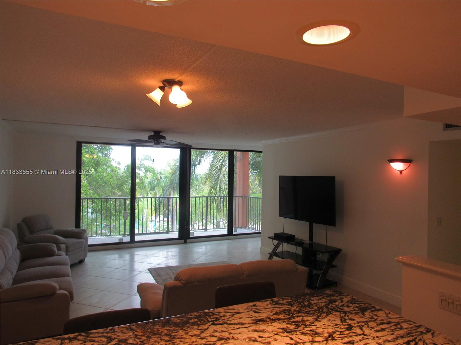 1101 River Reach Drive, Unit 418 Fort Lauderdale, FL 33315 - Photo 4 of 54 a living room with furniture and a flat screen tv