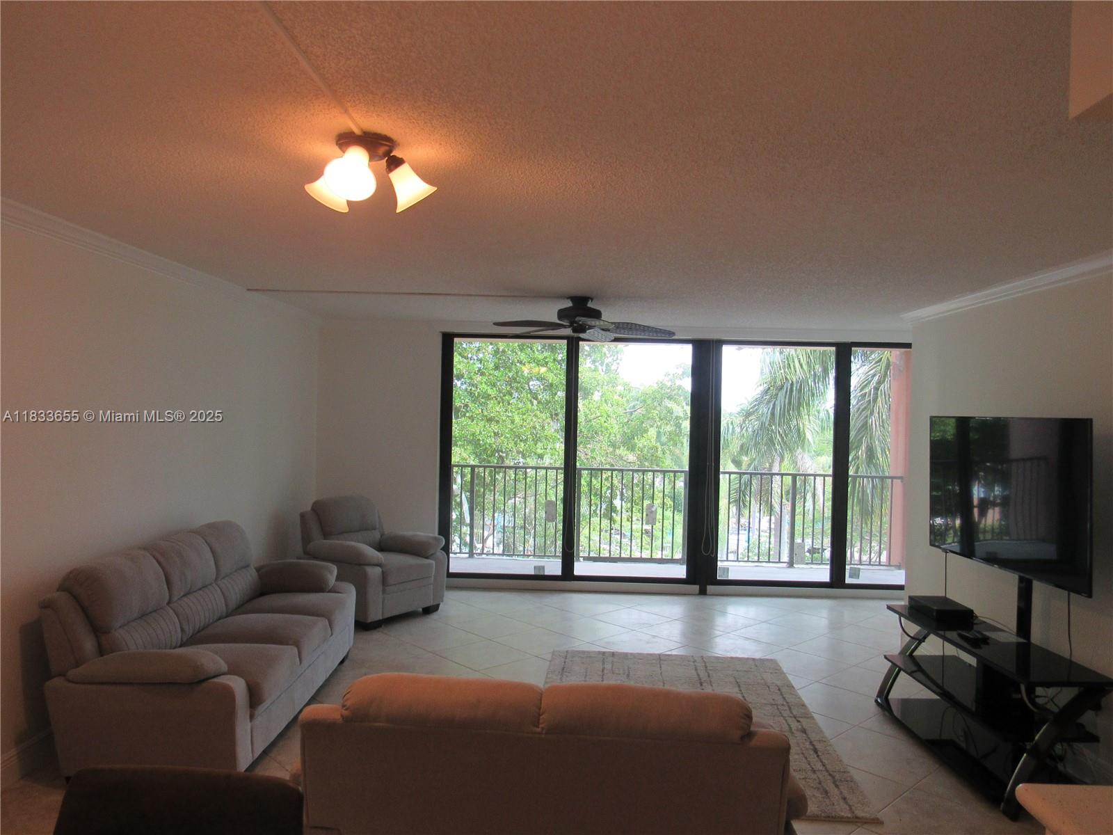 1101 River Reach Drive, Unit 418 Fort Lauderdale, FL 33315 - Photo 5 of 54 a living room with furniture and a flat screen tv