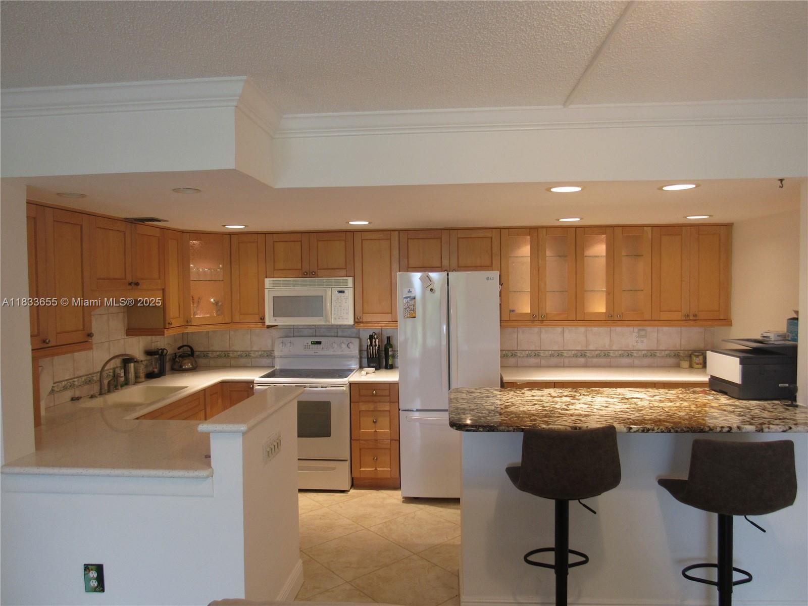 1101 River Reach Drive, Unit 418 Fort Lauderdale, FL 33315 - Photo 6 of 54 a kitchen with a sink cabinets and stainless steel appliances