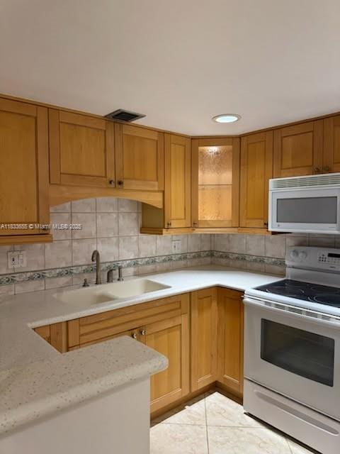 1101 River Reach Drive, Unit 418 Fort Lauderdale, FL 33315 - Photo 9 of 54 a kitchen with a sink stove top oven and cabinets