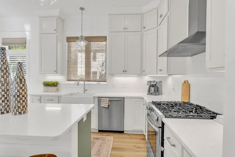a kitchen with a sink appliances and cabinets
