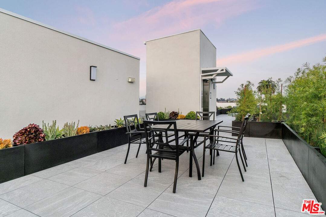3632 Keystone Avenue, Unit 302 Los Angeles, CA 90034 - Photo 11 of 38 a view of outdoor dining space with a table and chairs