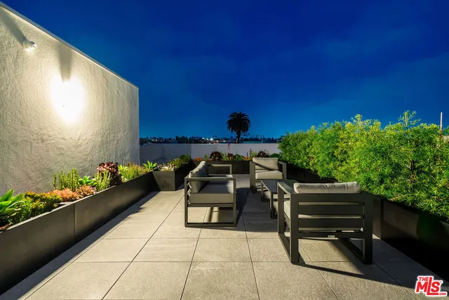 a large kitchen with stainless steel appliances granite countertop a stove a sink and a microwave