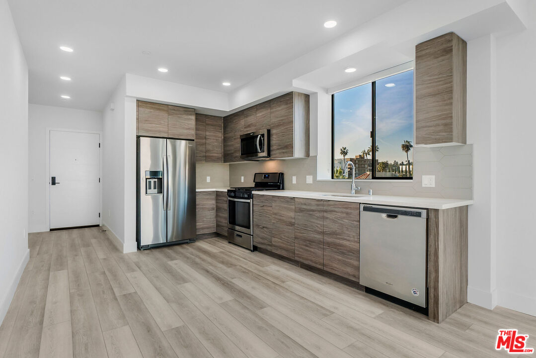 3632 Keystone Avenue, Unit 302 Los Angeles, CA 90034 - Photo 26 of 38 a kitchen with stainless steel appliances a refrigerator sink and microwave