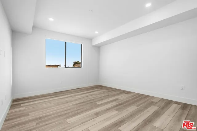 a view of a room with wooden floor