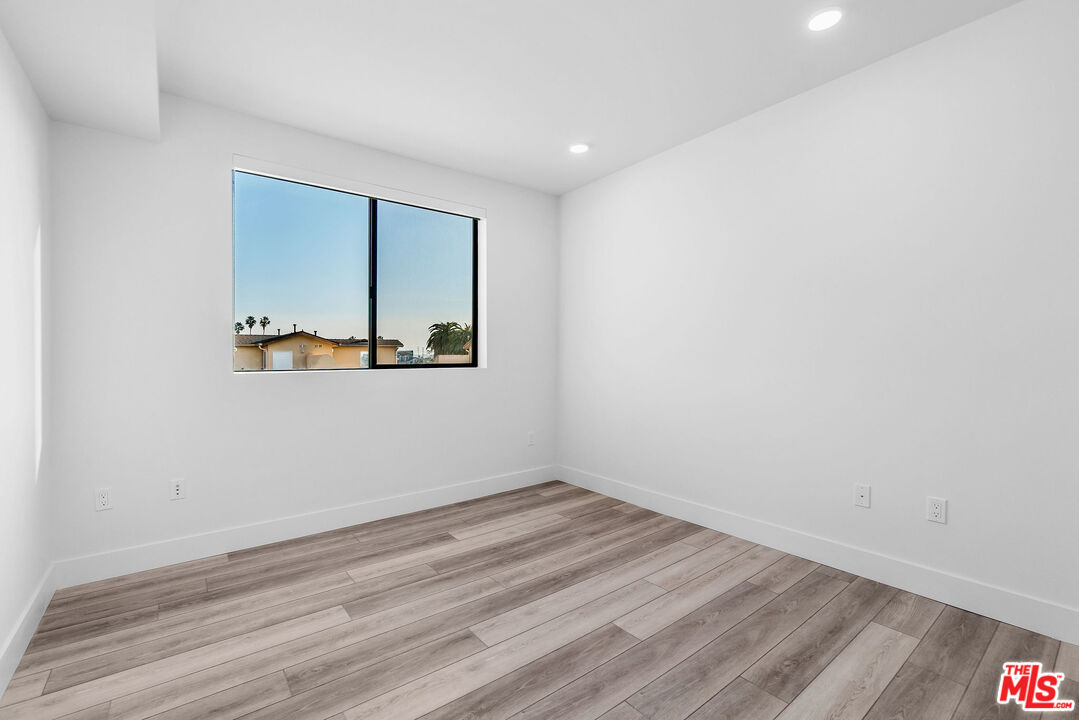 3632 Keystone Avenue, Unit 302 Los Angeles, CA 90034 - Photo 36 of 38 a view of an empty room with wooden floor and a window