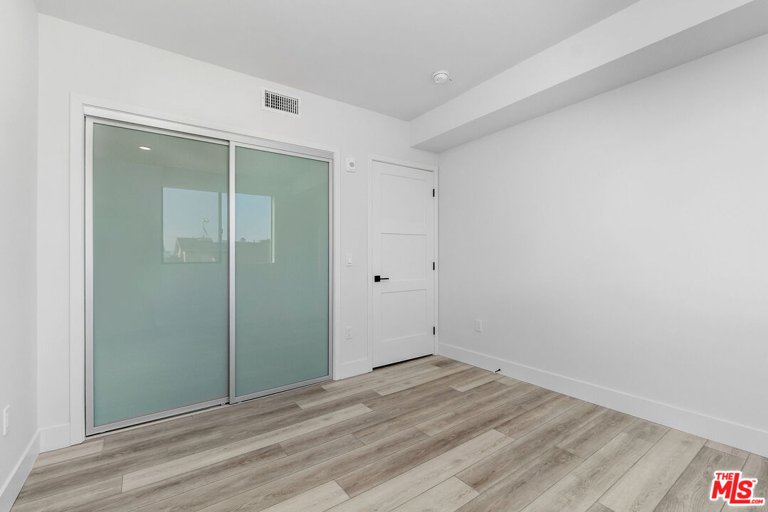 3632 Keystone Avenue, Unit 302 Los Angeles, CA 90034 - Photo 37 of 38 a view of a room with wooden floor