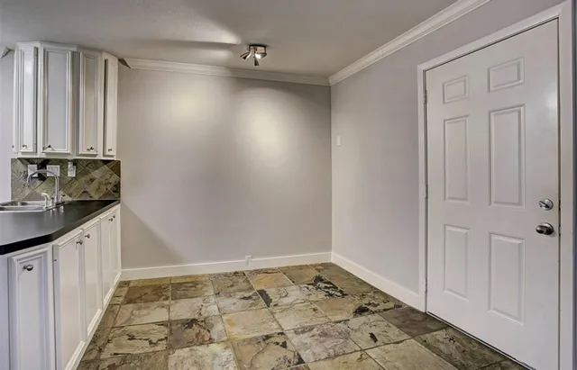 a view of an empty room and staircase