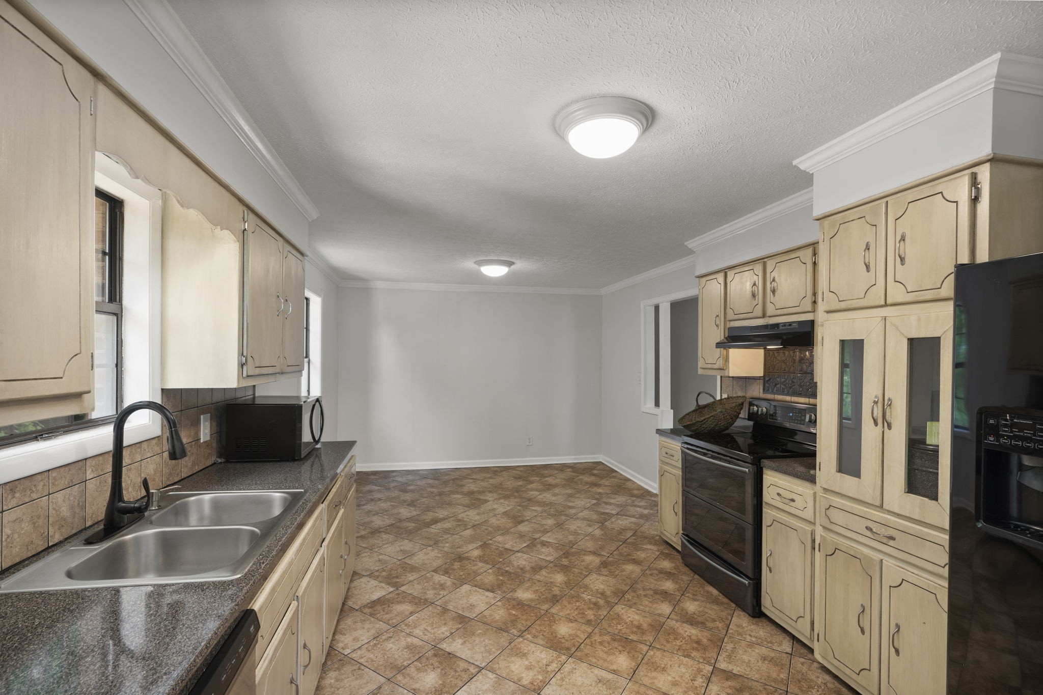 450 Fowler Ford Road Portland, TN 37148 - Photo 8 of 20 a kitchen with granite countertop a refrigerator and a sink