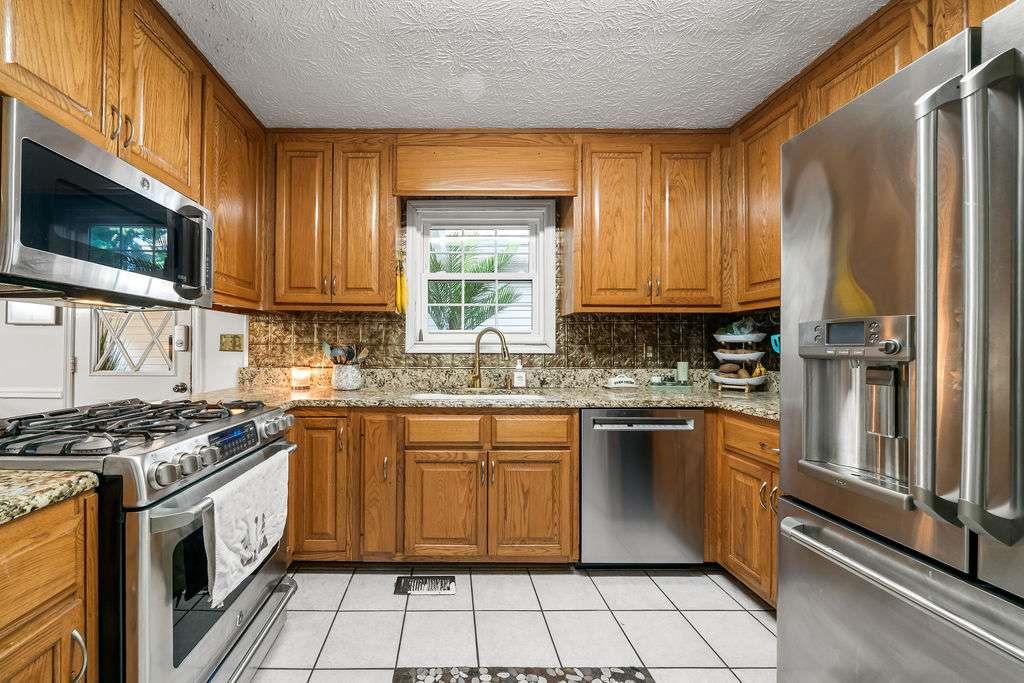 7 College View Drive Southwest Rome, GA 30161 - Photo 17 of 49 a kitchen with stainless steel appliances granite countertop a stove a sink and a microwave