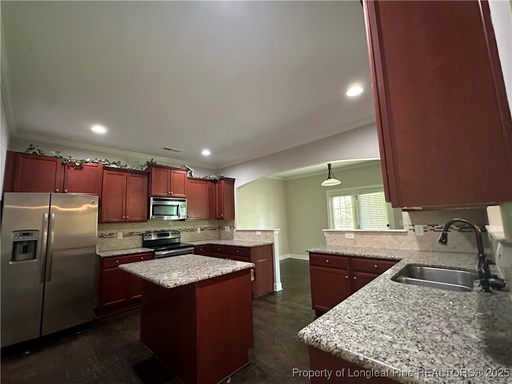 1024 Micahs Way North Spring Lake, NC 28390 - Photo 16 of 43 a kitchen with stainless steel appliances granite countertop a sink stove and refrigerator