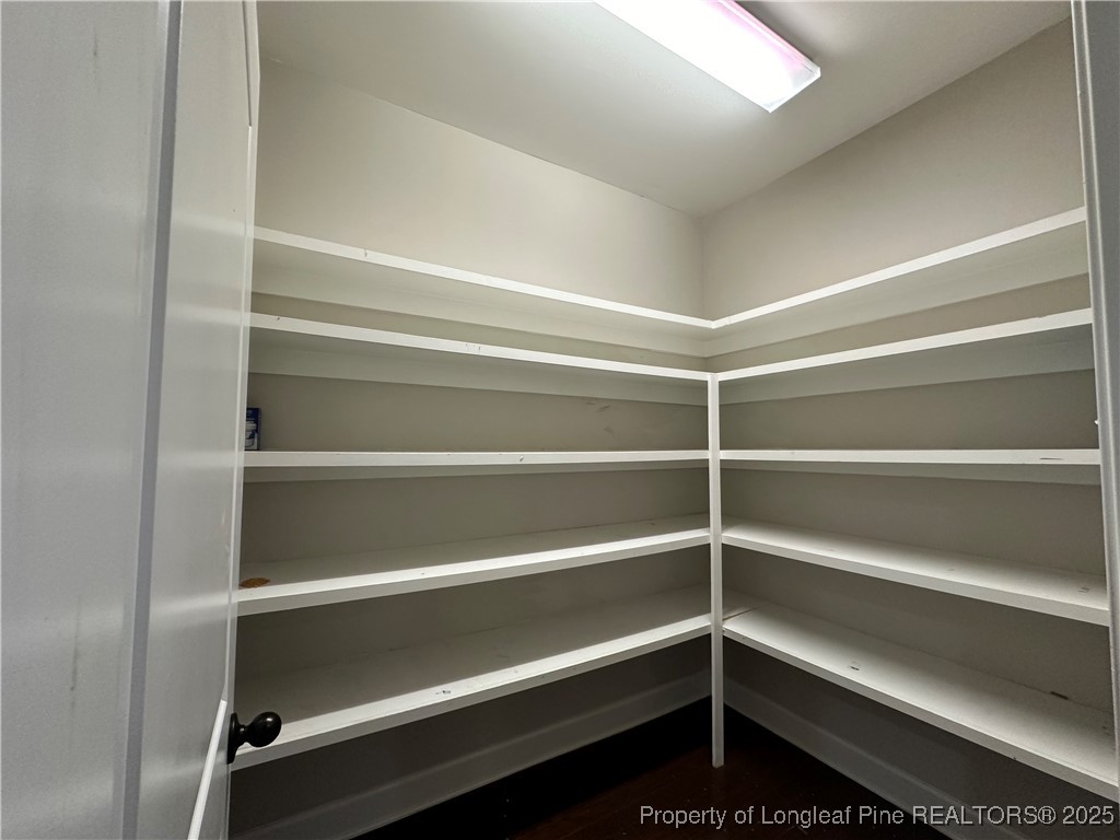 1024 Micahs Way North Spring Lake, NC 28390 - Photo 17 of 43 a view of walk in closet with empty racks