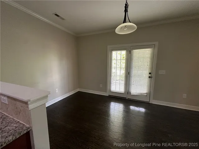 a view of a livingroom with wooden floor and a window