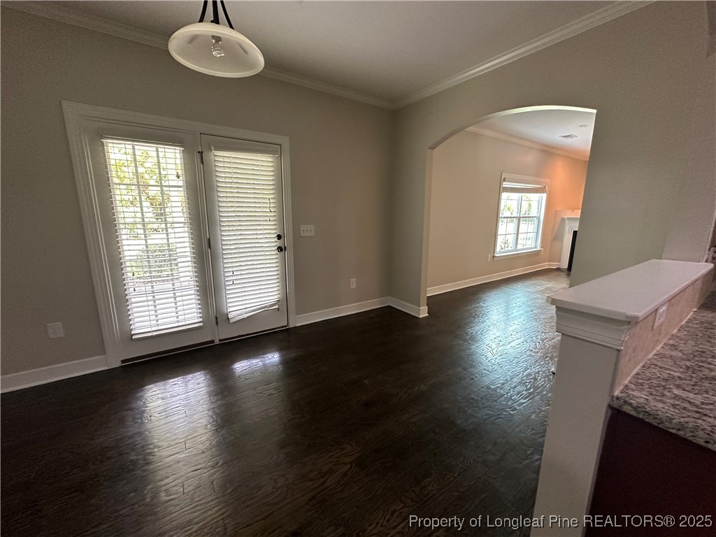 1024 Micahs Way North Spring Lake, NC 28390 - Photo 19 of 43 a view of an empty room with wooden floor and a window