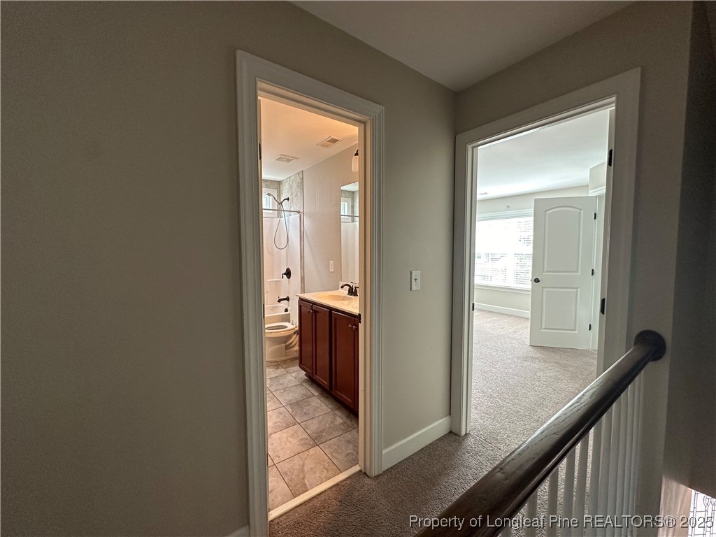 1024 Micahs Way North Spring Lake, NC 28390 - Photo 23 of 43 a view of a hallway with a livingroom and a bathroom with sink
