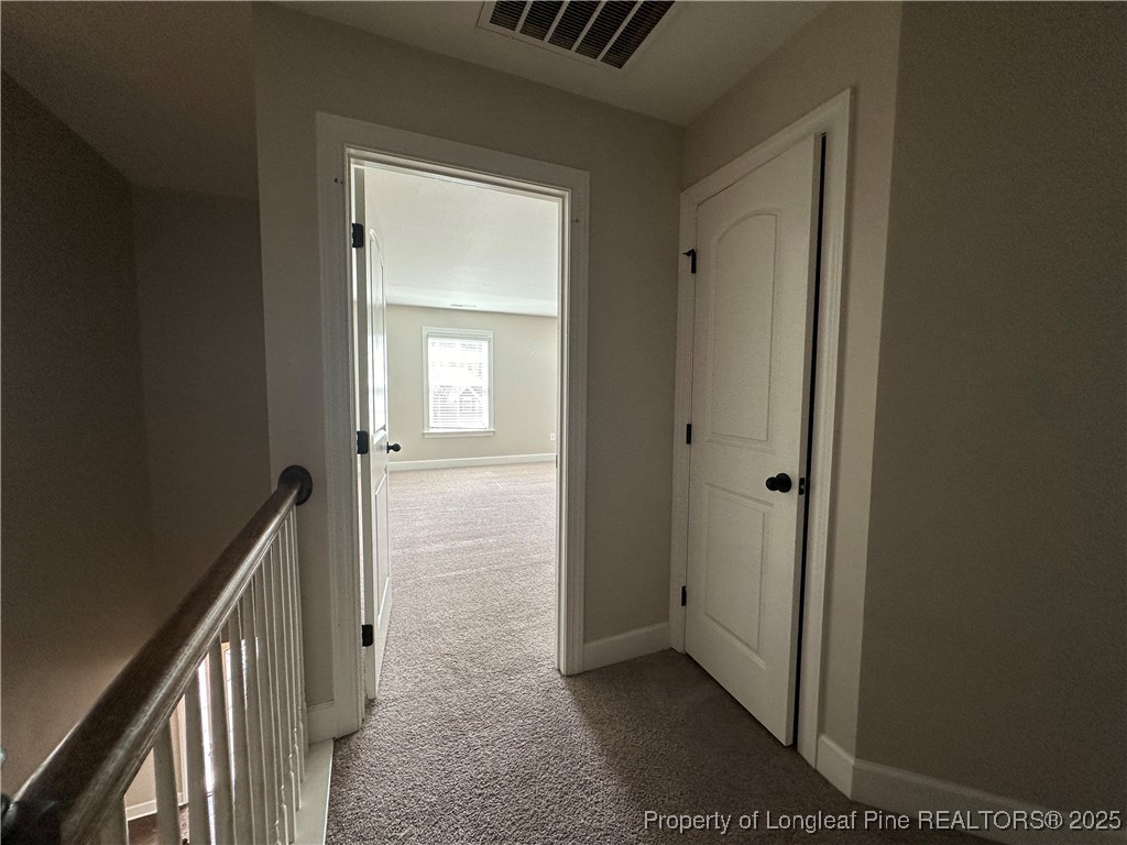 1024 Micahs Way North Spring Lake, NC 28390 - Photo 28 of 43 a view of a hallway with wooden floor and a hallway