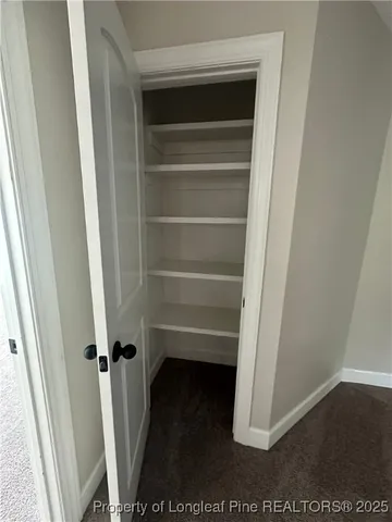 a view of a house with brick walls and a yard with potted plants